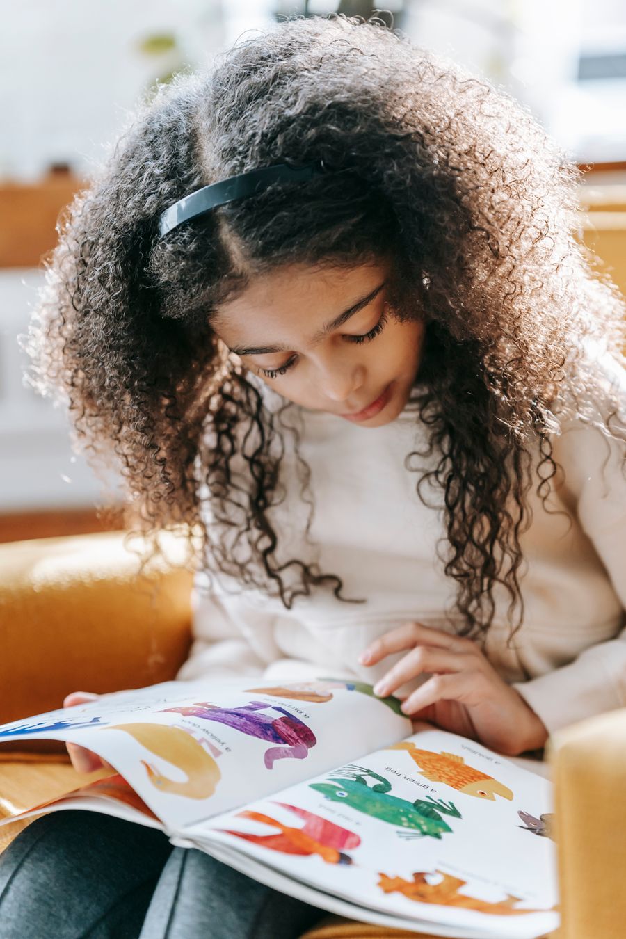 A child reading a picture book at home
