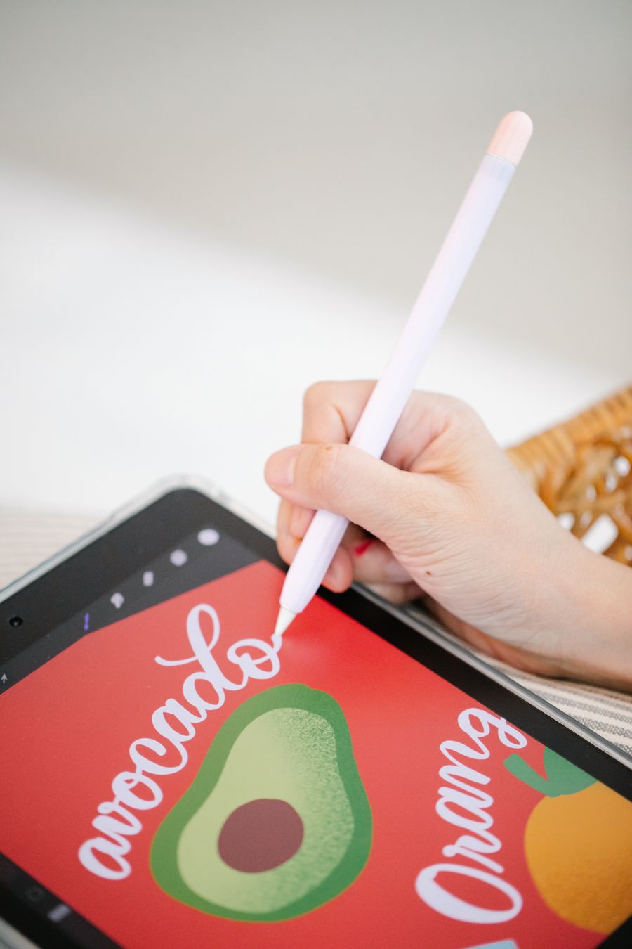 A kid drawing on a tablet with a stylus
