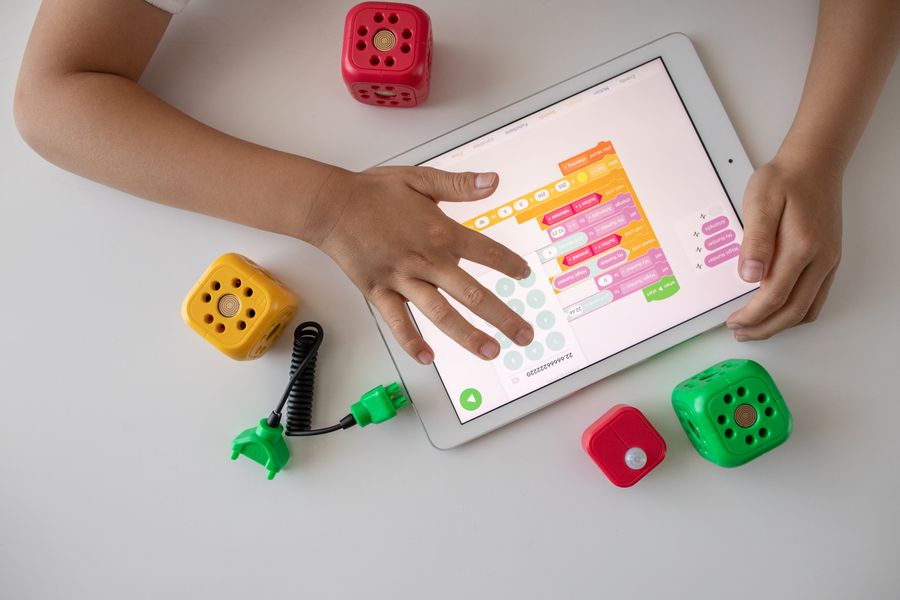 A kid building something of their own with toy blocks