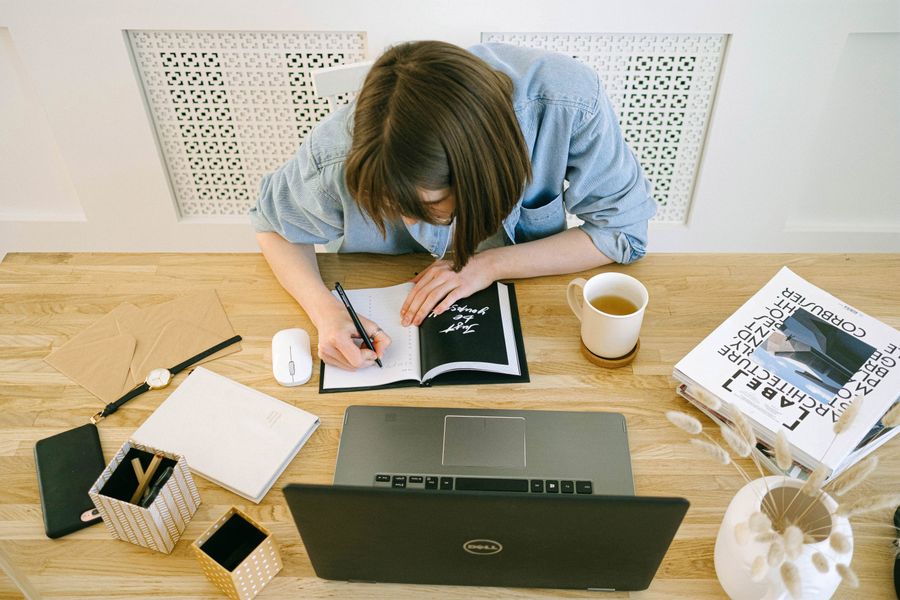 Working on a website with a notebook and laptop at home